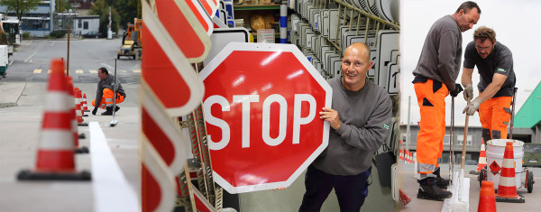 Kollegen bei der Markierung einer Straße, Kollege mit STOP-Schild