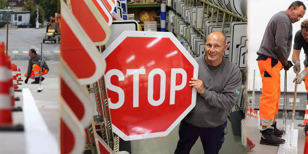 Kollegen bei der Markierung einer Straße, Kollege mit STOP-Schild