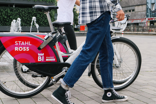 Jugendliche schieben Fahrräder mit der Aufschrift "Bielefeld fährt Rad".